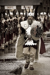 The 2009 Guizer Jarl Stephen Mouat leads his squad through the town. Photo by Andrew Shearer.